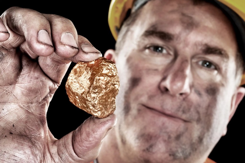 17_06_20-a-gold-miner-holding-up-a-gold-nugget-_gettyimages-134059493.jpg