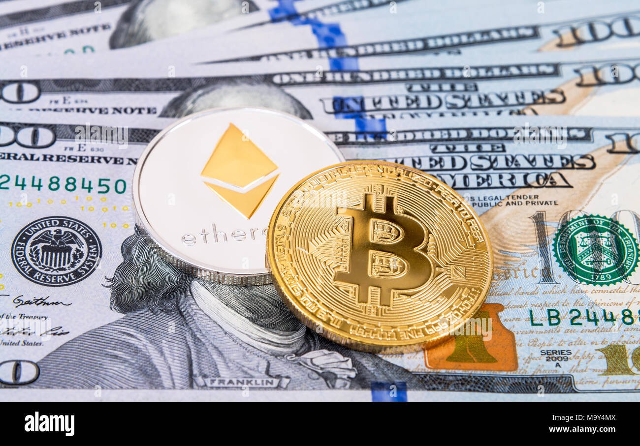 digital-cryptocurrency-bitcoin-and-ethereum-lying-on-the-one-hundred-american-dollar-bills-business-concept-of-new-virtual-money-M9Y4MX.jpg